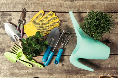 Gardener at work with safety equipment and tools in a residential garden